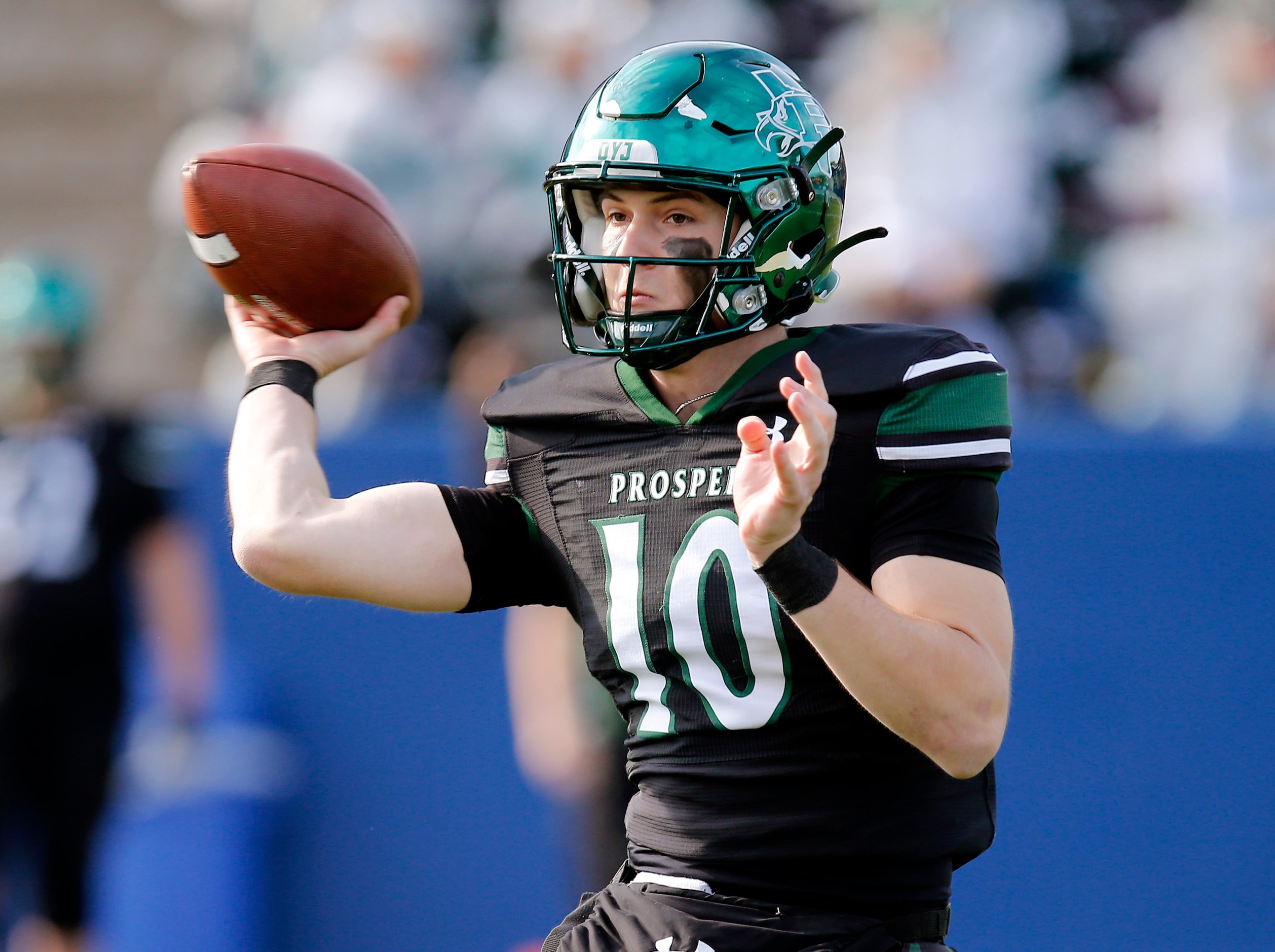 Prosper High School quarterback Harrison Rosar (10) throws a touchdown pass on the first...