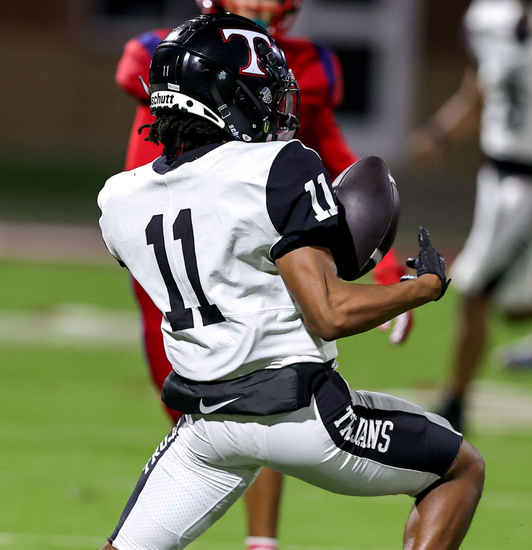 Trinity wide receiver Antwan McGee juggles the ball but comes up with the reception against...