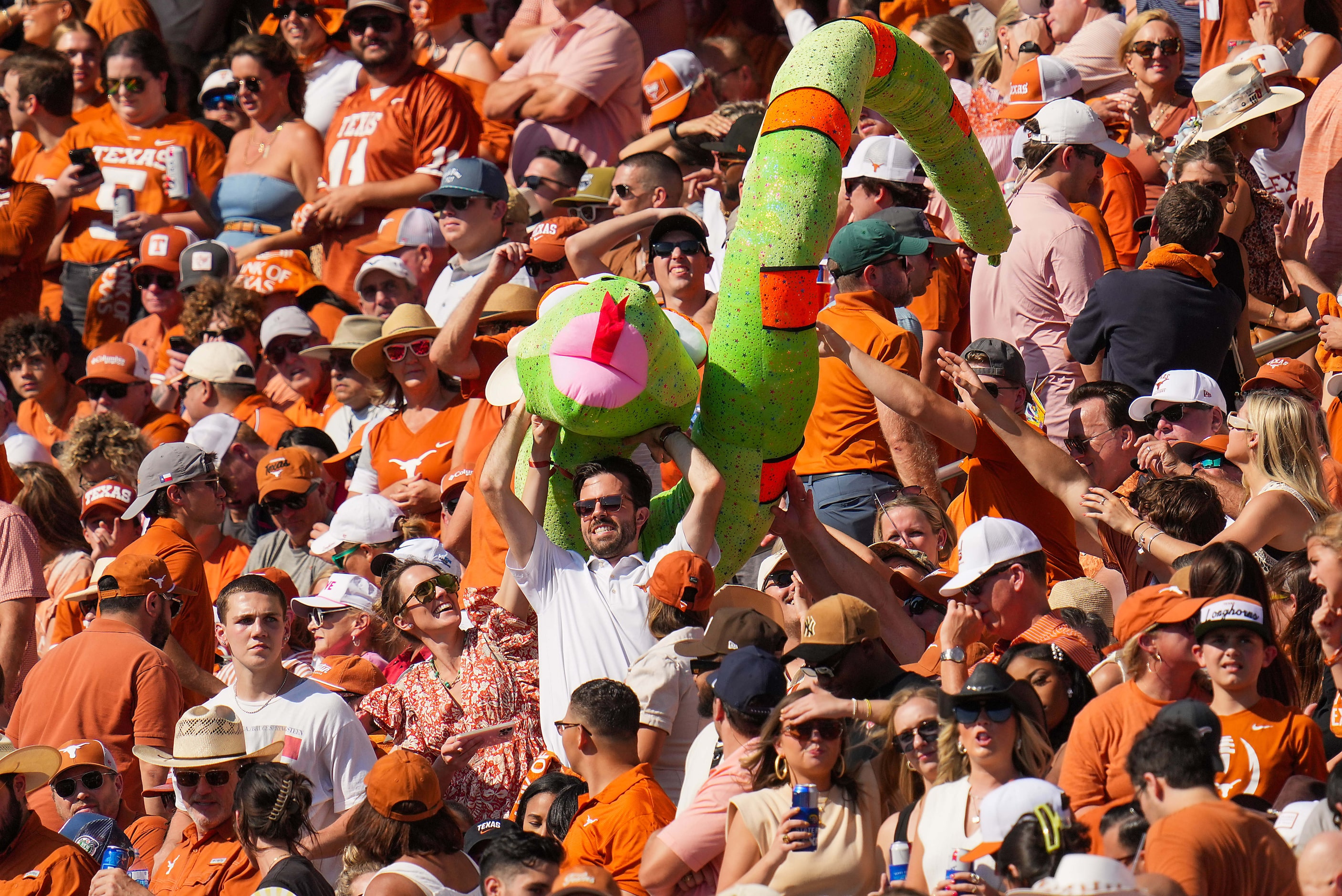 Fans toss an inflatable toy through the stands during the first half of an NCAA college...