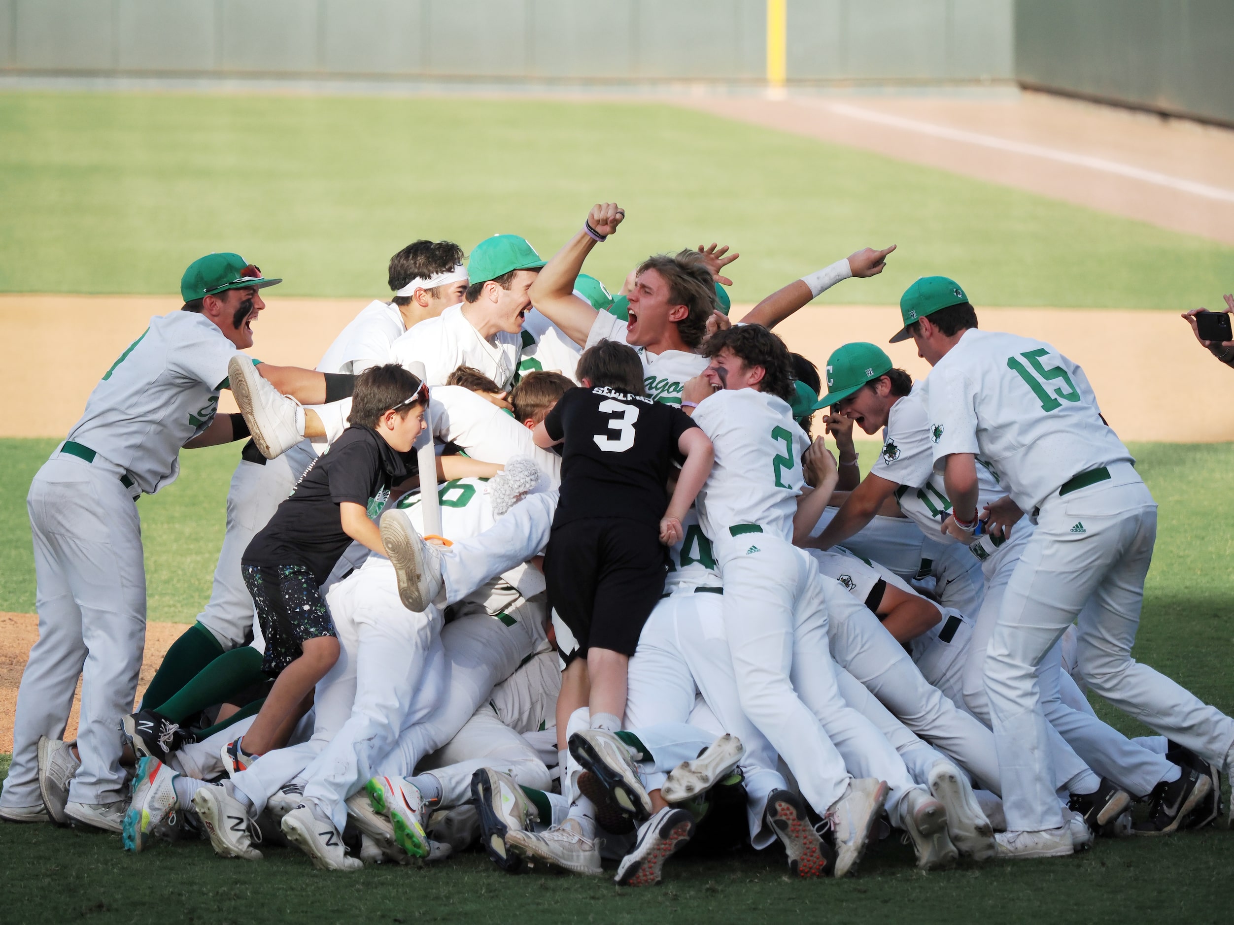 Southlake Carroll players react after defeating San Antonio Reagan in the UIL baseball 6A...