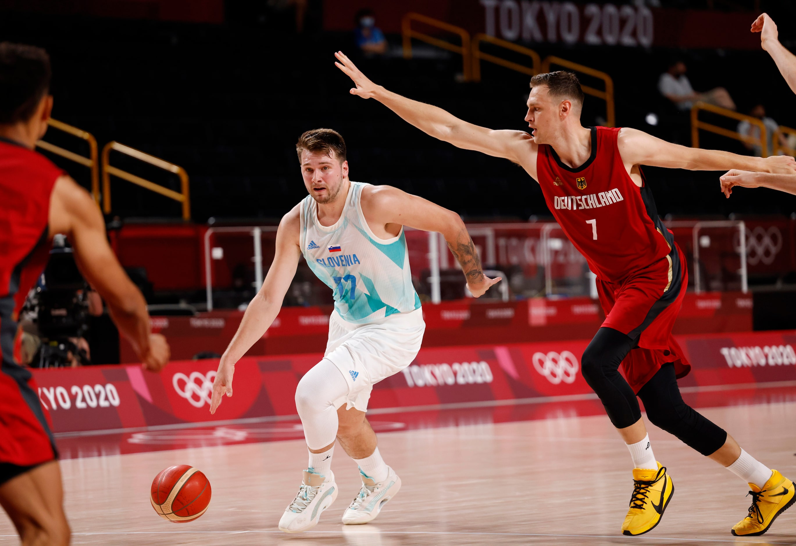 Slovenia’s Luka Doncic (77) drives on Germany’s Johannes Voigtmann (7) during the first half...