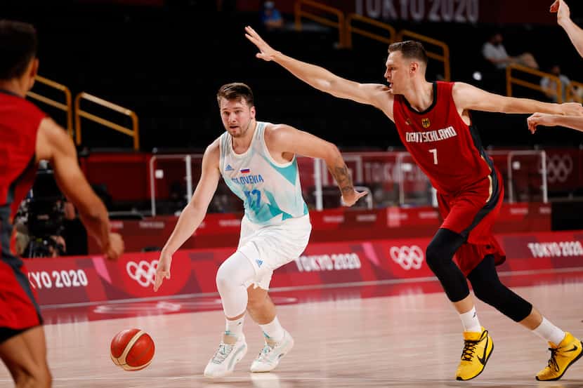 Slovenia’s Luka Doncic (77) drives on Germany’s Johannes Voigtmann (7) during the first half...