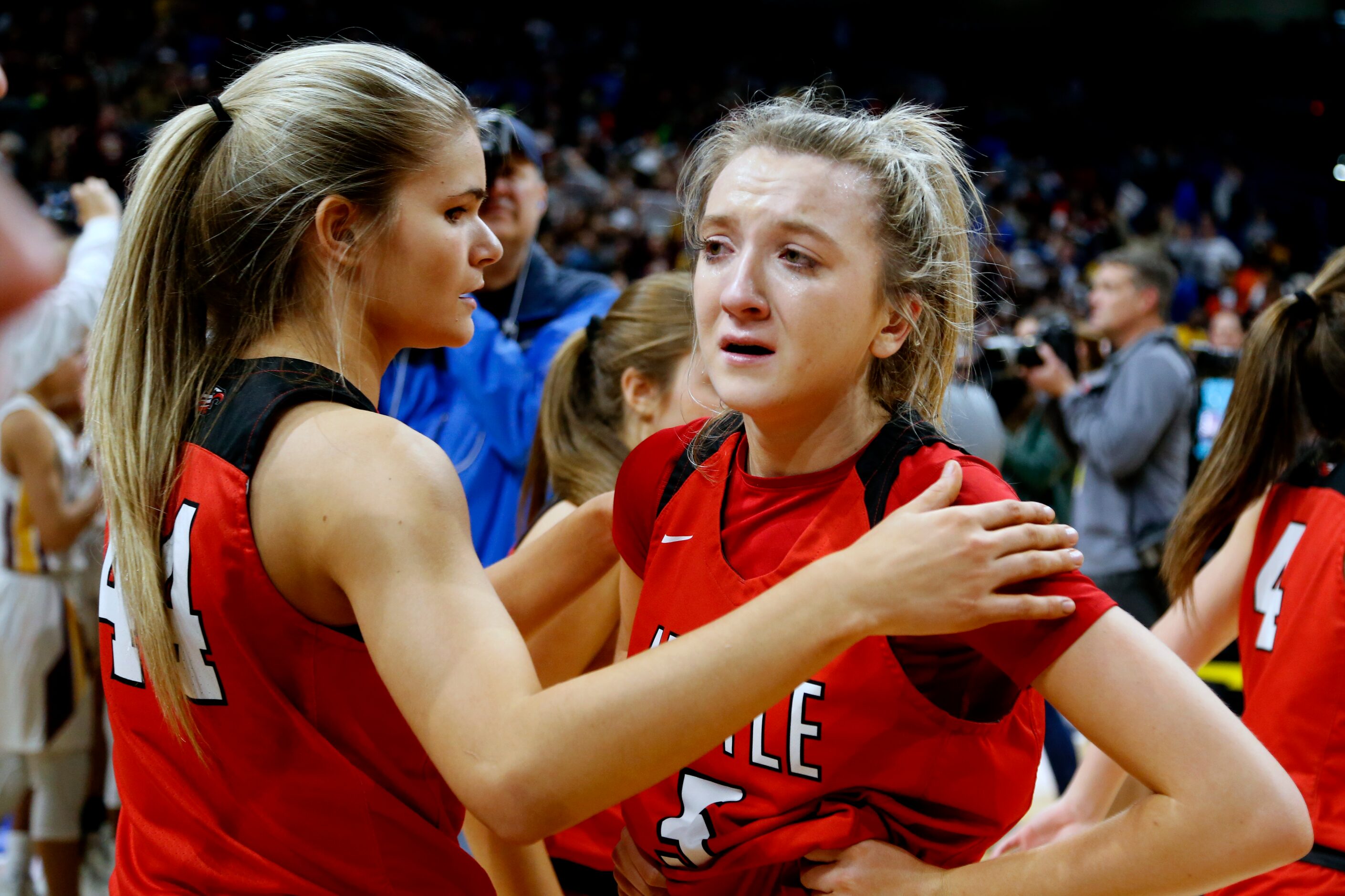 Argyle guard Rhyle McKinney #5 is consoled by Argyle forward Megan Netzelman #44 after...