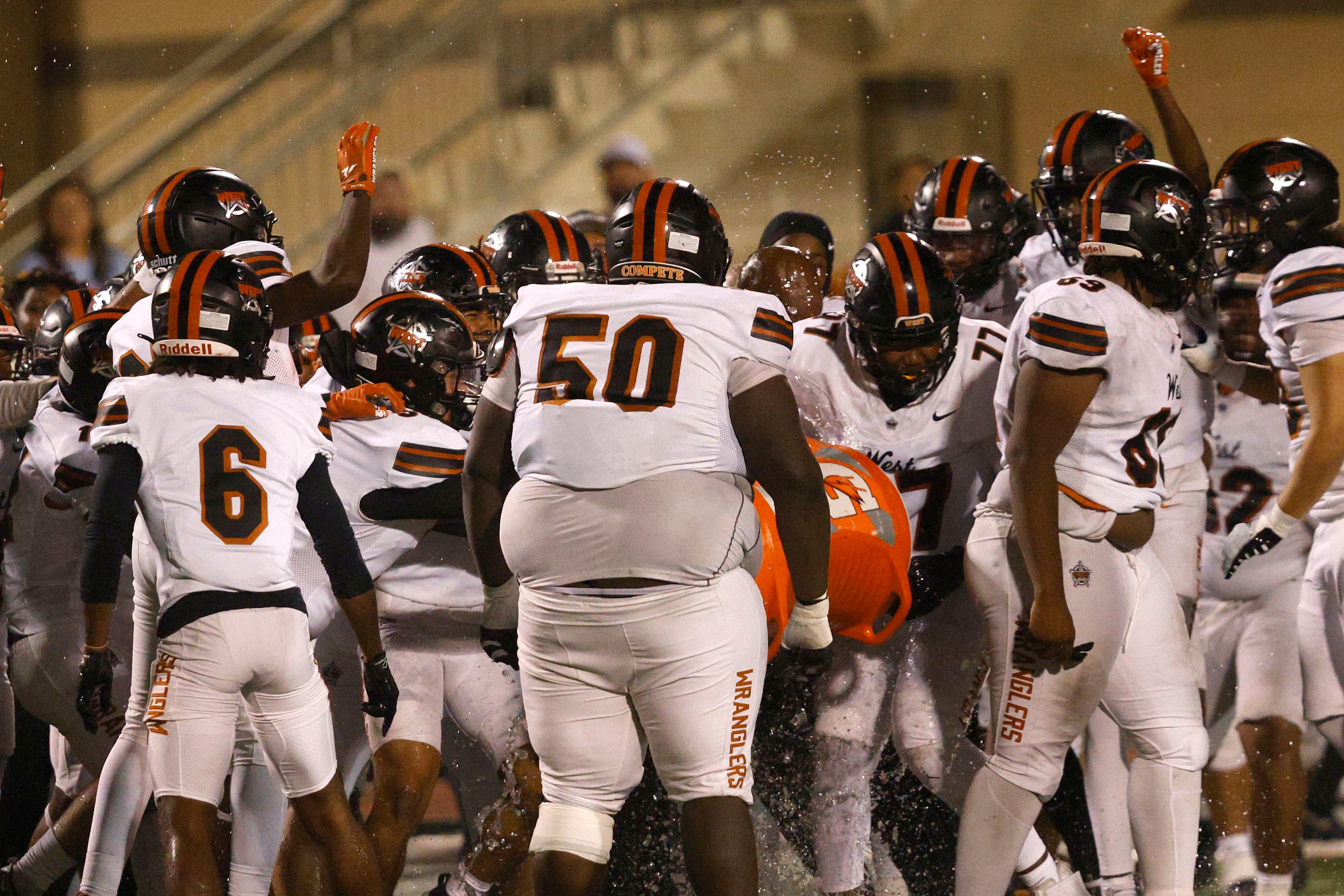 West Mesquite players celebrate their 20-13 victory against Newman Smith after a high school...