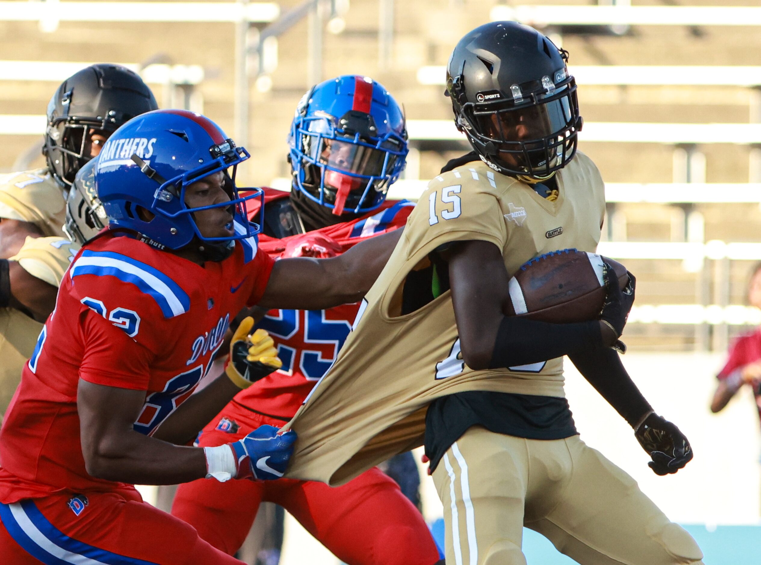 Duncanville High School Nathan McCoy (82) holds South Oak Cliff High School Tedrick Williams...