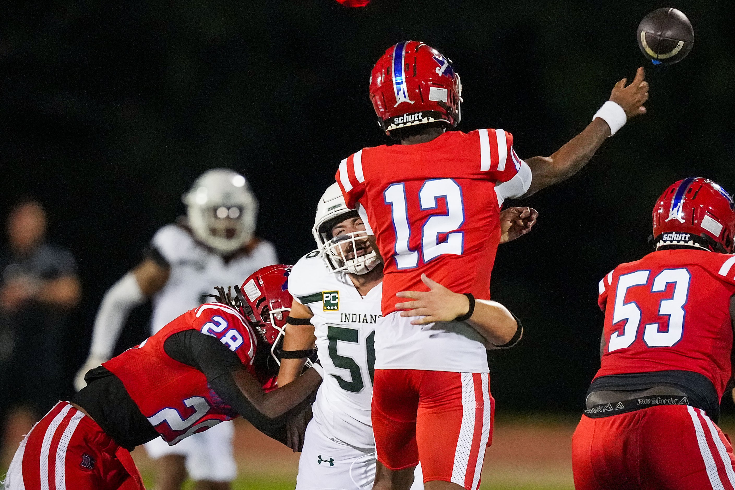 Duncanville quarterback Keelon Russell (12) gets off a pass as he is hit by Waxahachie...