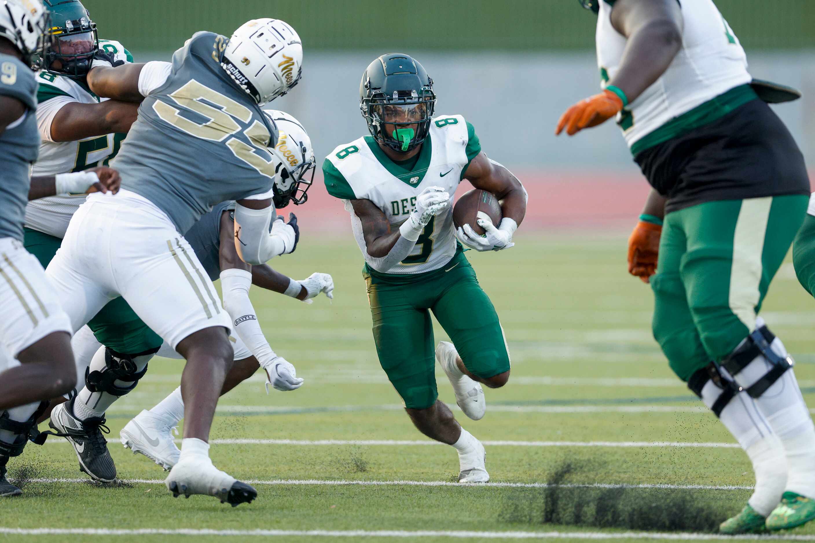 DeSoto running back Jaden Trawick (8) splits the South Oak Cliff defense as he runs the ball...