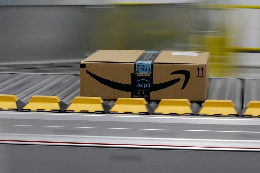 In this 2018 file photo, a box for an Amazon prime customer moves through the new Amazon...