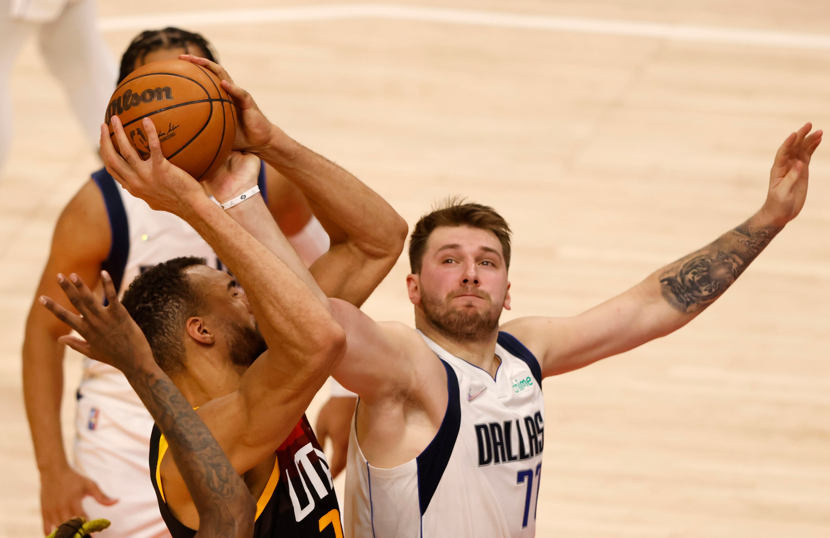 Dallas Mavericks guard Luka Doncic (77) fouls Utah Jazz center Rudy Gobert (27) as he grabs...