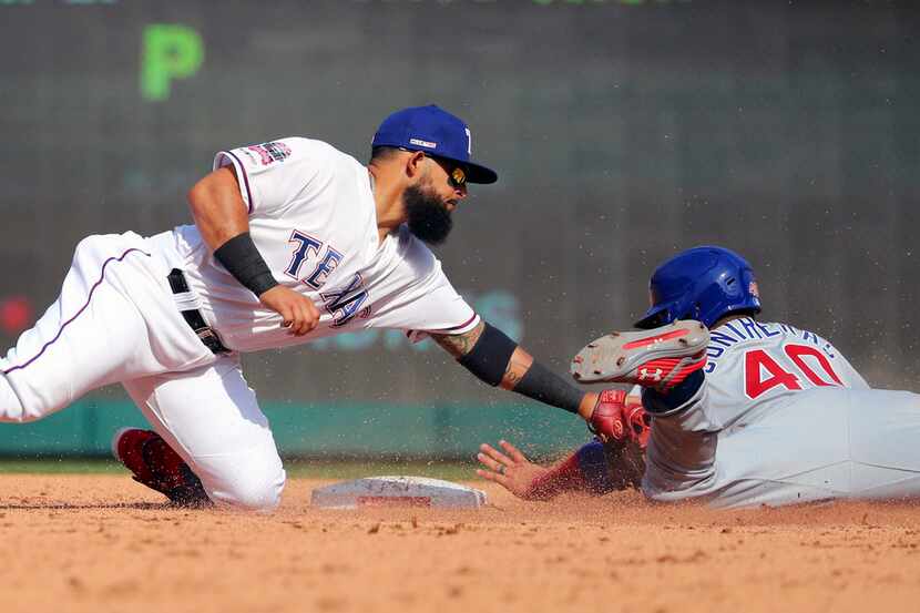 Texas Rangers second baseman Rougned Odor (12) tags out Chicago Cubs Willson Contreras (40)...