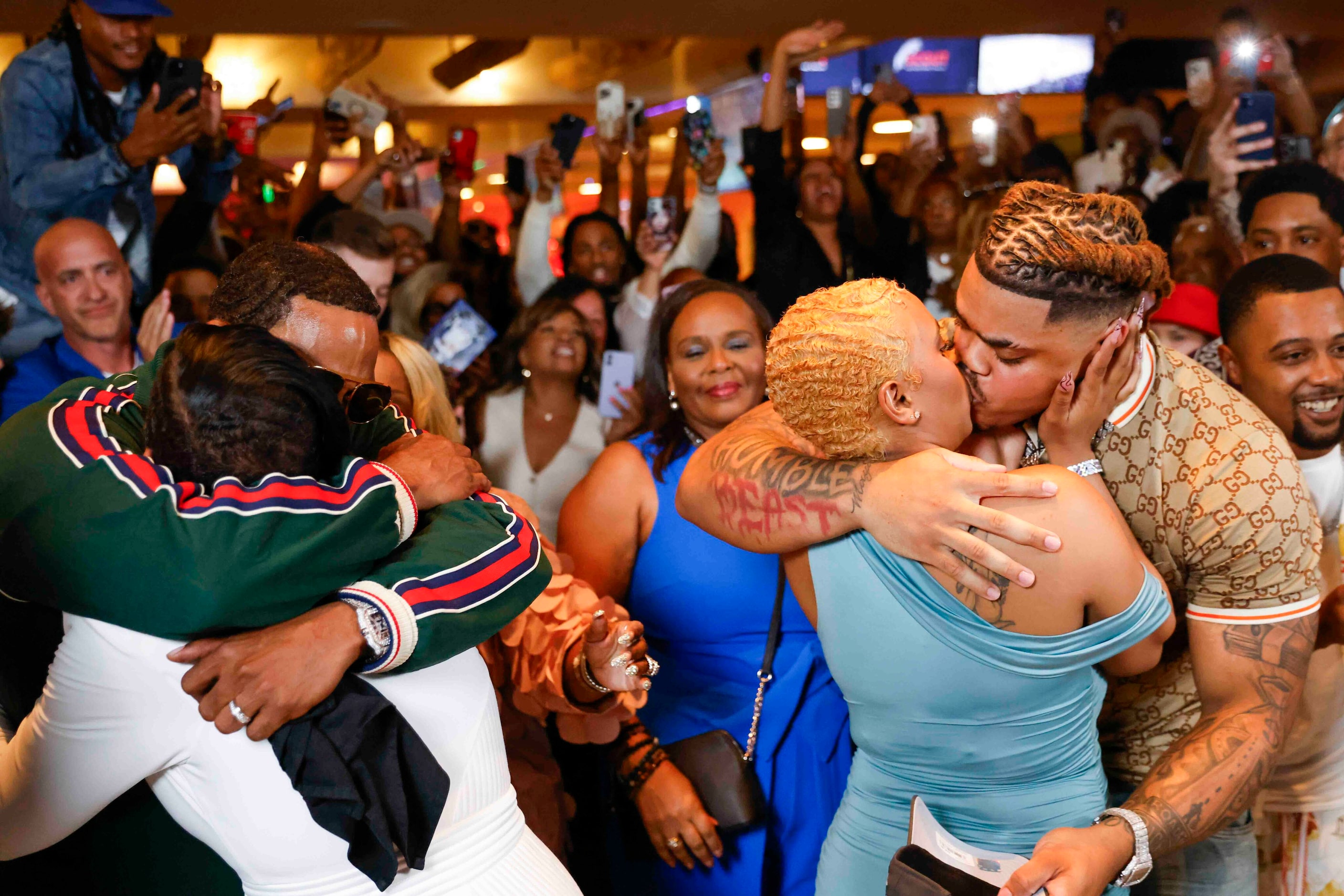 Texas Defensive tackle Byron Murphy II (right) shares kiss with his partner as his father...