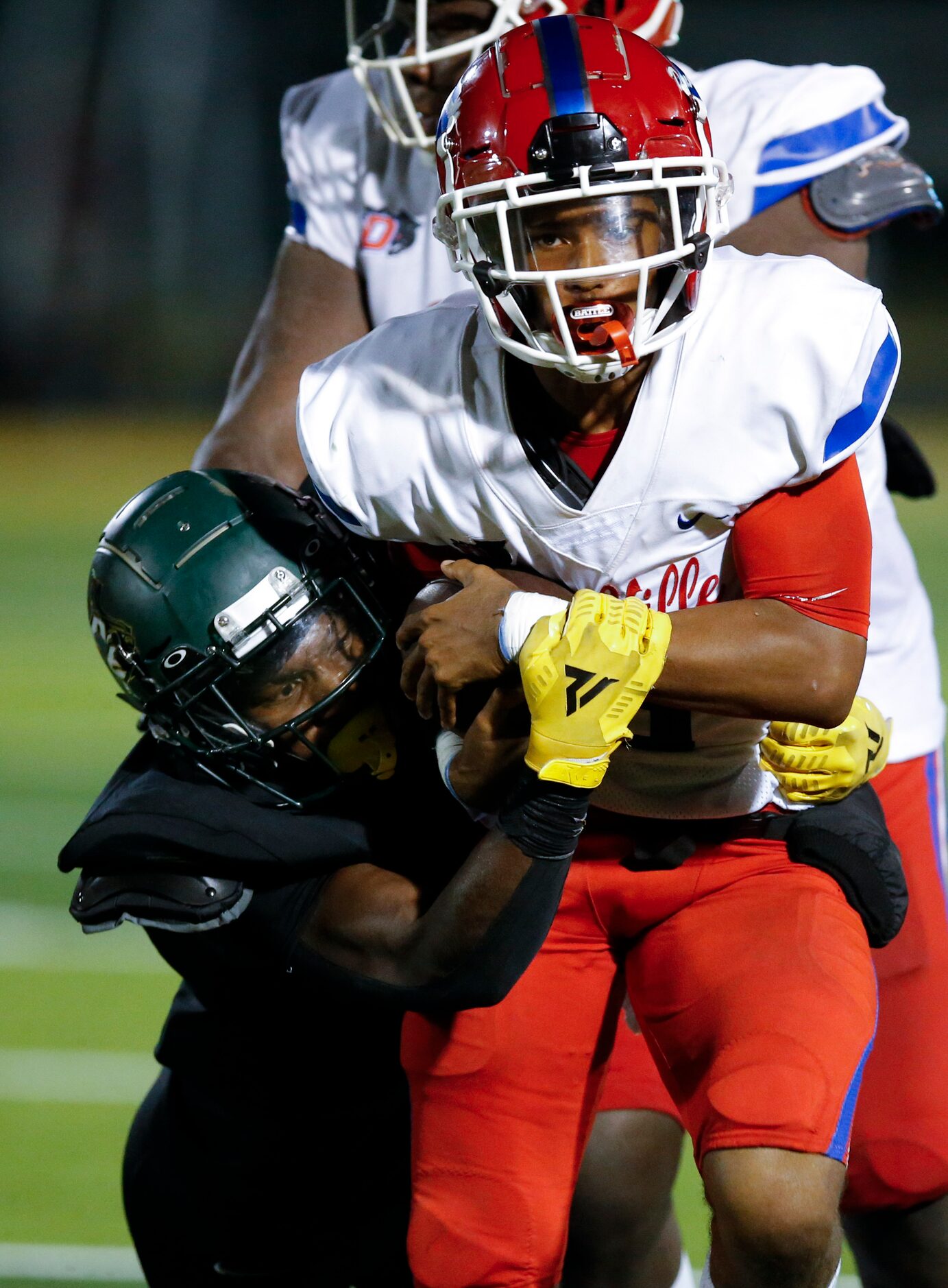 DeSoto senior defensive back Devyn Bobby, left, tackles Duncanville senior quarterback...