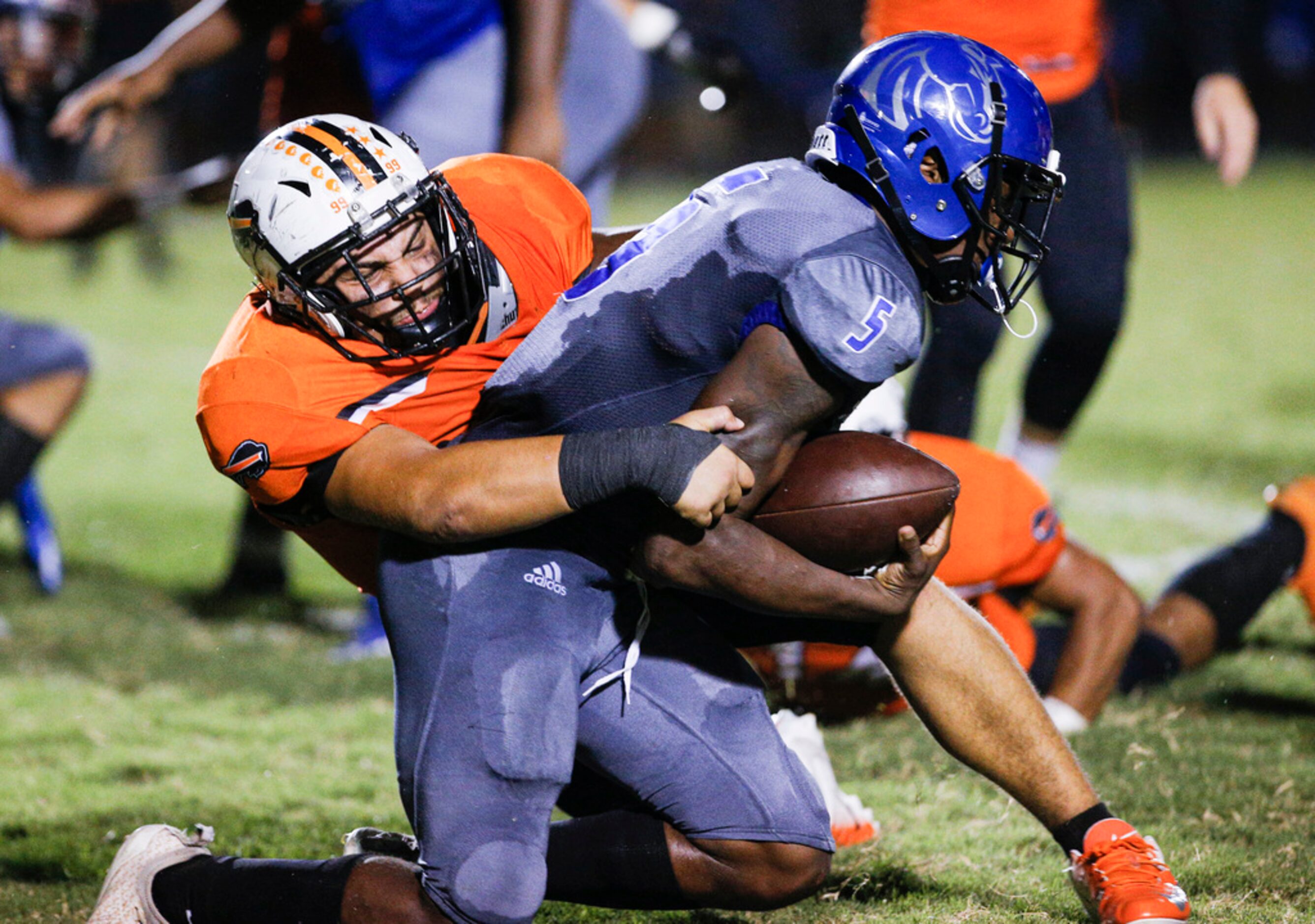 TXHSFB Haltom City sophomore defensive lineman Gerardo Tejeda (99) tackles North Mesquite...