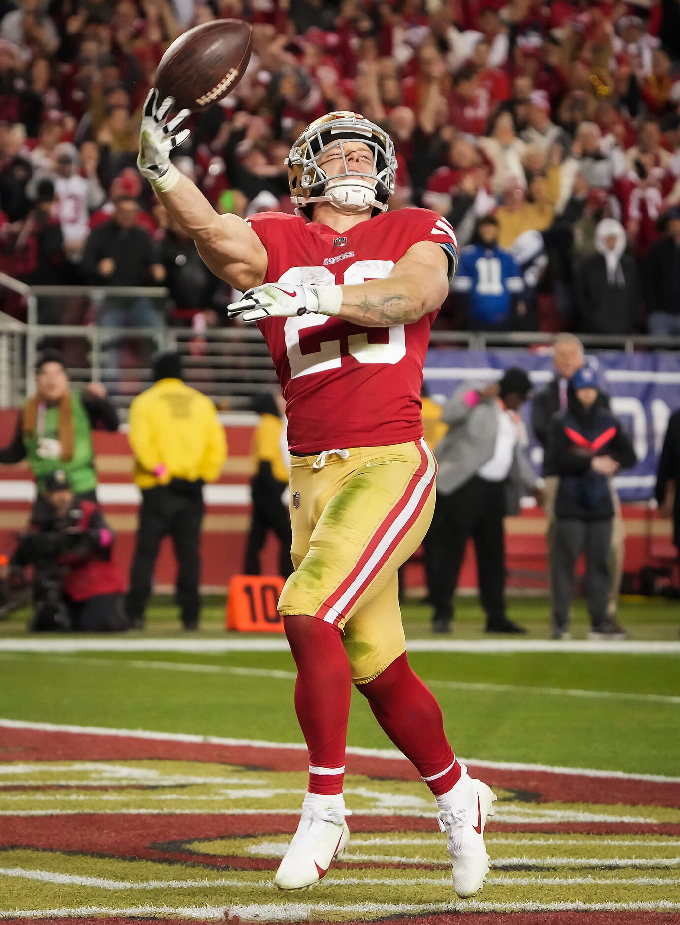 San Francisco 49ers running back Christian McCaffrey (23) tosses the ball in celebration...