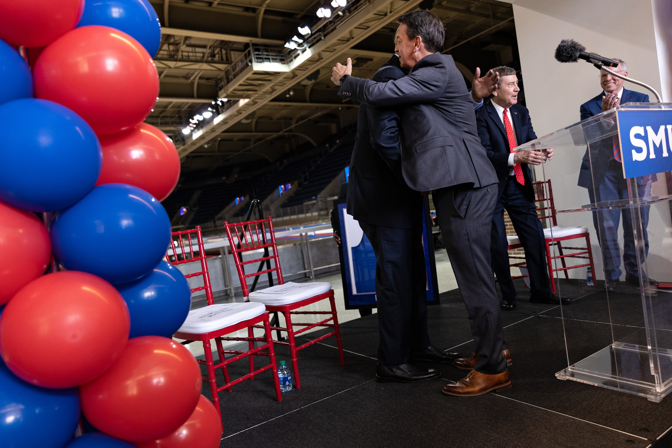 SMU’s new Head Men’s Basketball Coach Rob Lanier hugs Director of Athletics Rick Hart during...