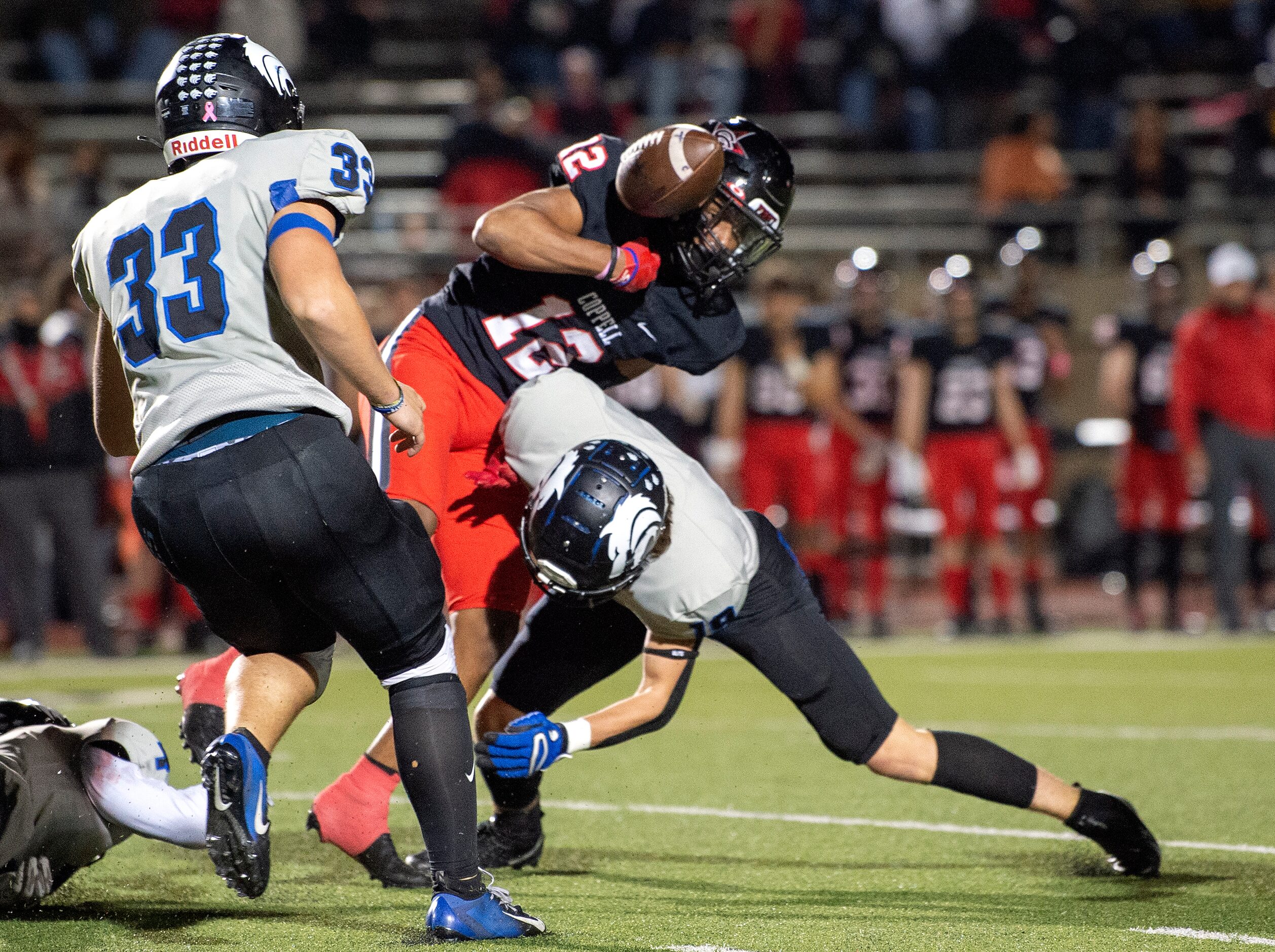 Coppell junior running back Dylan Nelson (12) fumbles as he is hit by Plano West senior...