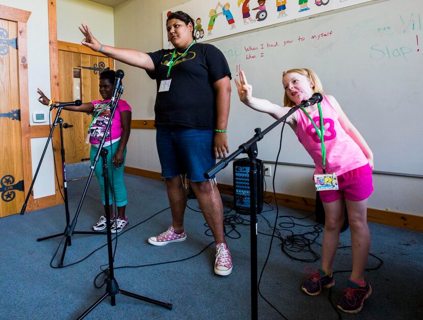 
Adamiria Green (center), 14 , says Camp I-Thonka-Chi helped her come to terms with her...