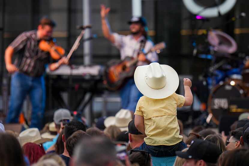 A youngster cheers as Ian Munsick performs during the ACM Country Kickoff fan festival at...