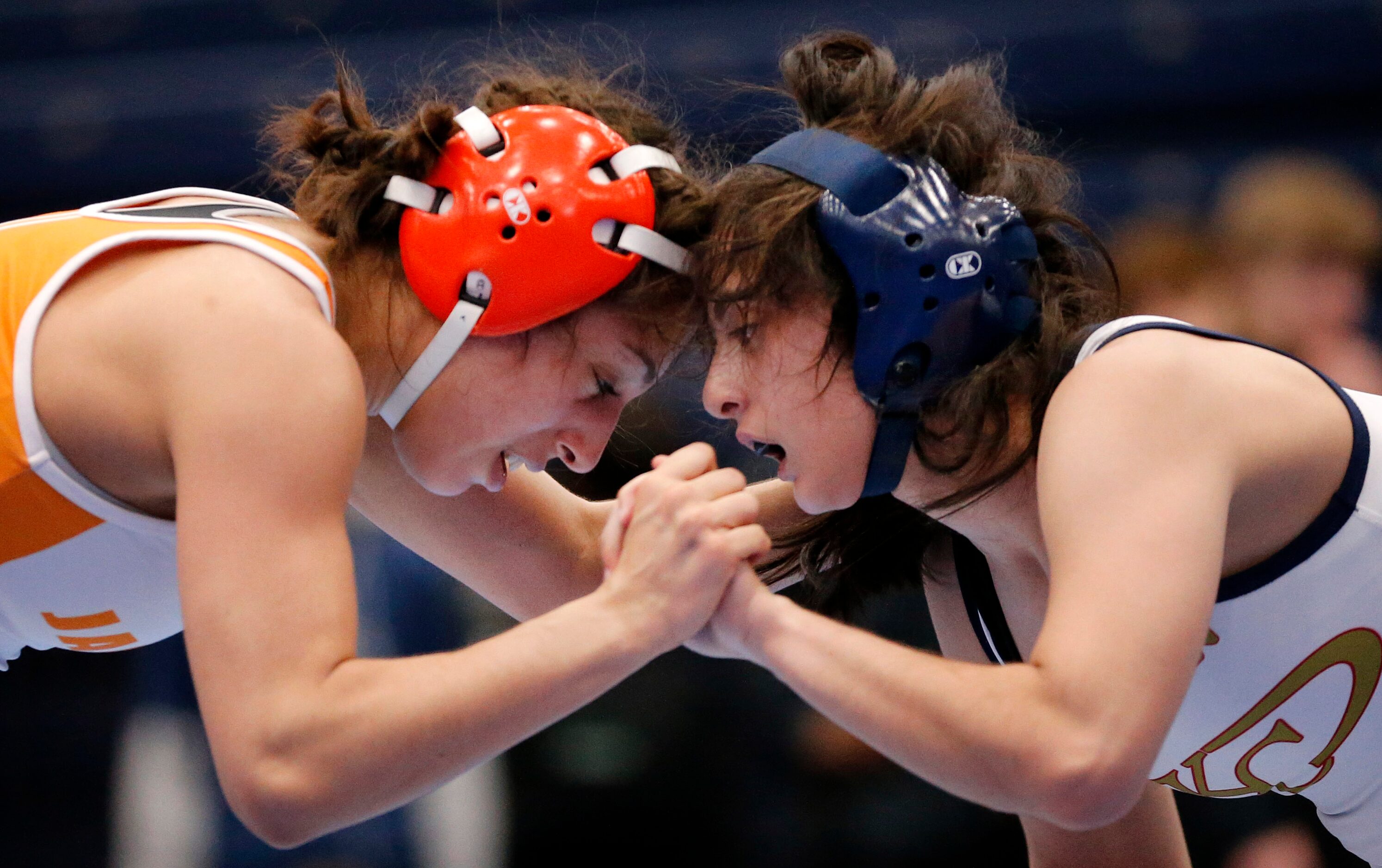 Rockwall girls wrestler Mia Arceneaux (left) ties up with Klein Collins High's Ashley Morris...