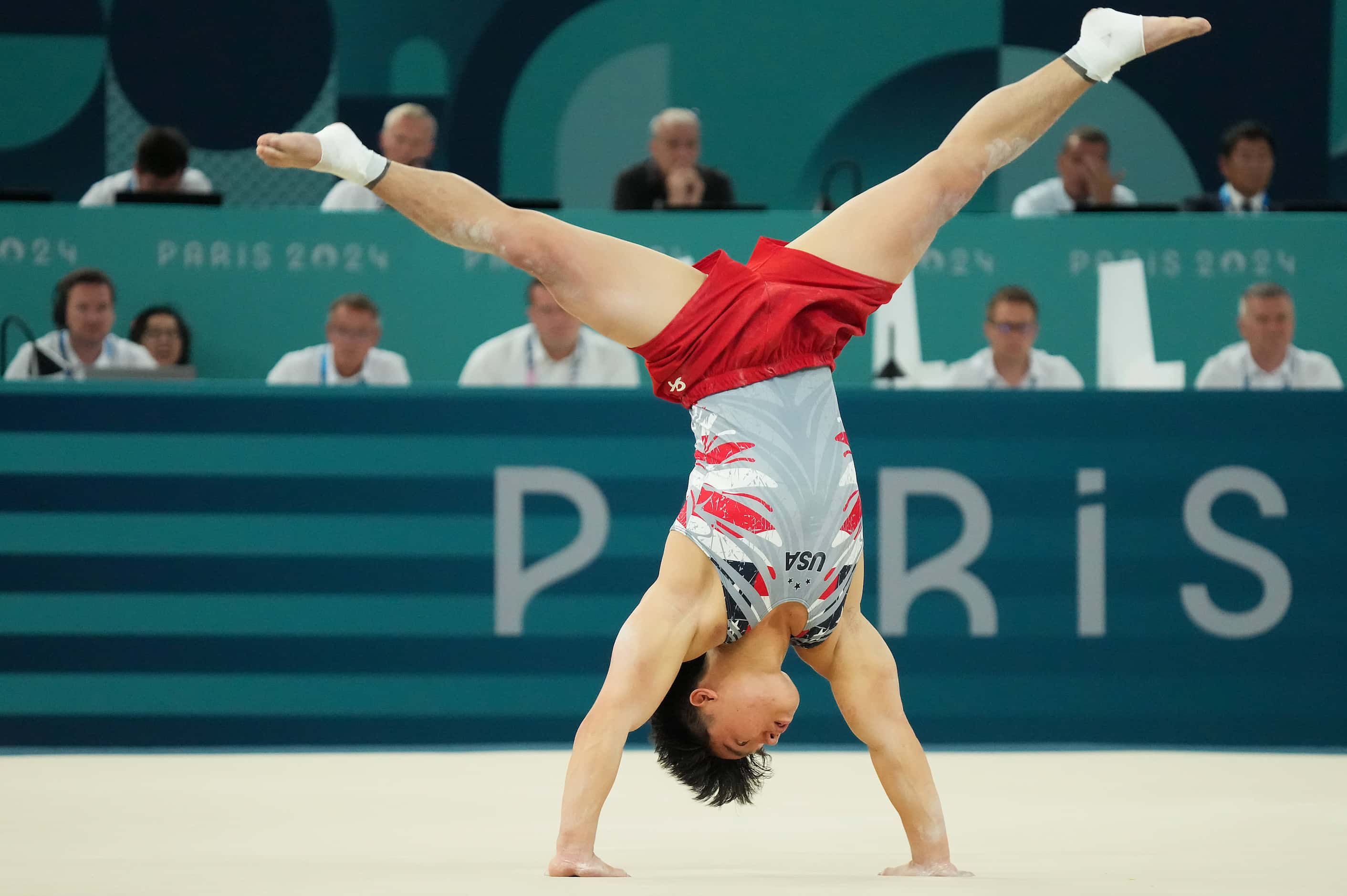 Asher Hong of the United States competes on the floor during the men’s gymnastics team final...