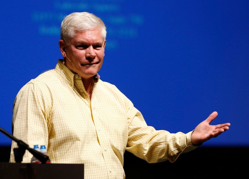 Rep. Pete Sessions, R-Dallas, reacts after the crowd erupted during the question portion of...