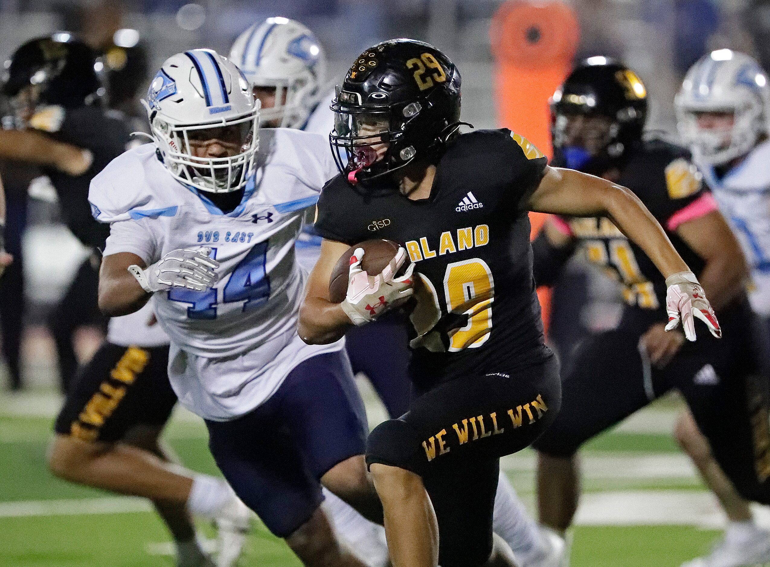 Garland High School wide receiver Jether Hughes runs with the ball as Wylie East High School...