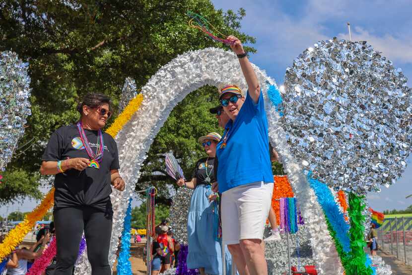 Wendy Lopez (right), senior vice president and Texas executive of AECOM, gave out beads on...