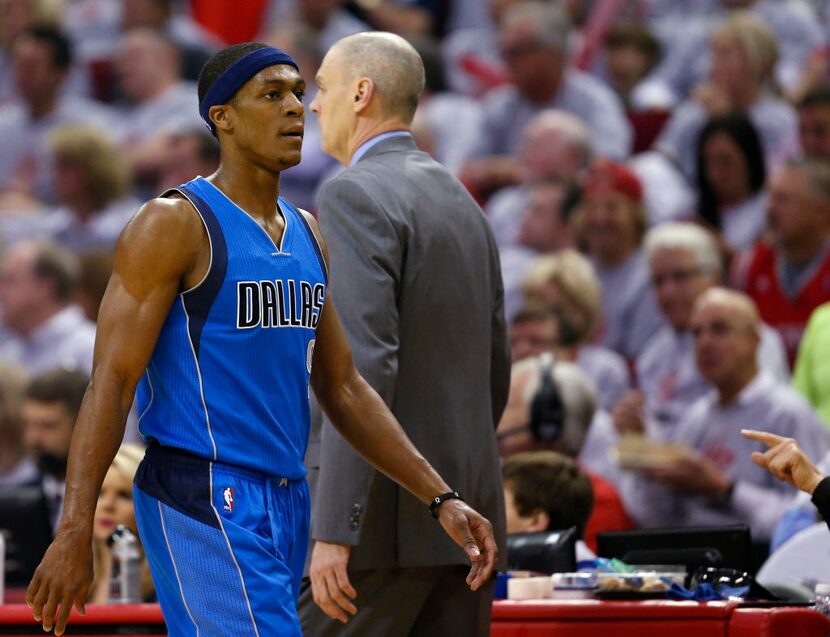 Dallas Mavericks guard Rajon Rondo (9) walks to the bench, passing Coach Rick Carlisle,...