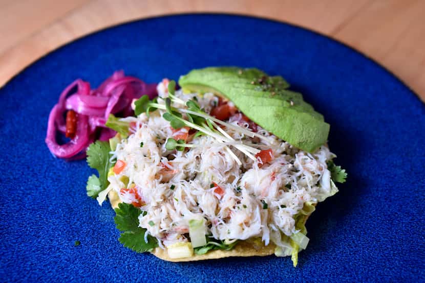 Crab tostada with avocado, pickled radish and mint labneh is a light and refreshing starter.