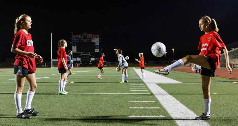 
Coppell Cowgirls teammates Tara Vishnesky (left) and Grace Vowell, both seniors, pass a...