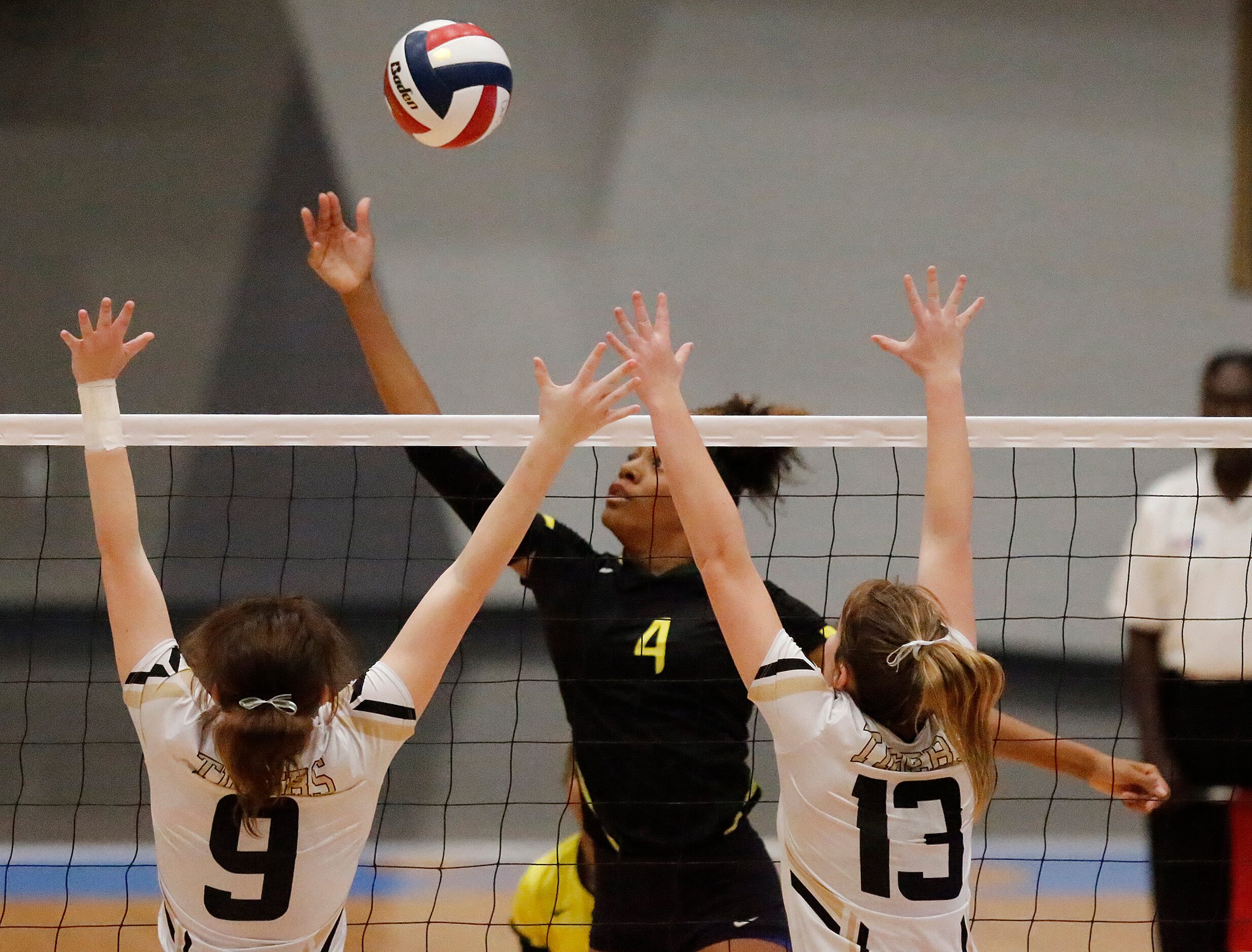 DeSoto High School outside hitter Caitlin Shaw (4) tips the ball over Mansfield High School...