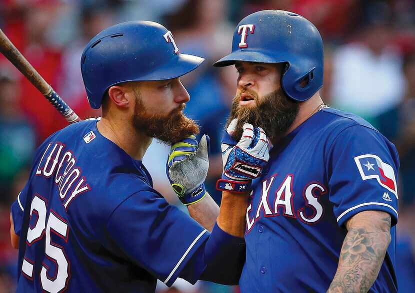 Rangers Mike Napoli (right) and teammate Jonathan Lucroy pull each other's beards after...