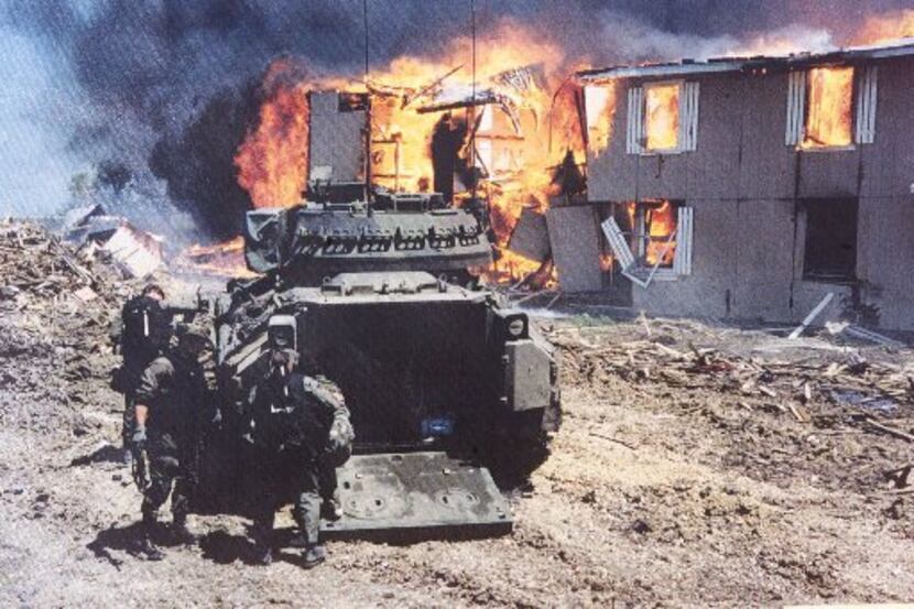 HRT team members give medical attention to Branch Davidian Ruth Riddle after Agent Jim McGee...