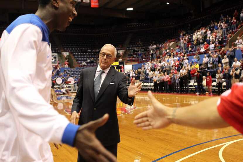 Southern Methodist Mustangs head coach Larry Brown greets player during announcements in the...
