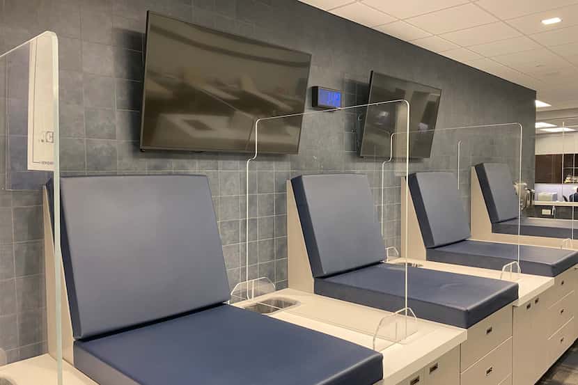 Plexiglass dividers separate the stations in the Cowboys' training room.