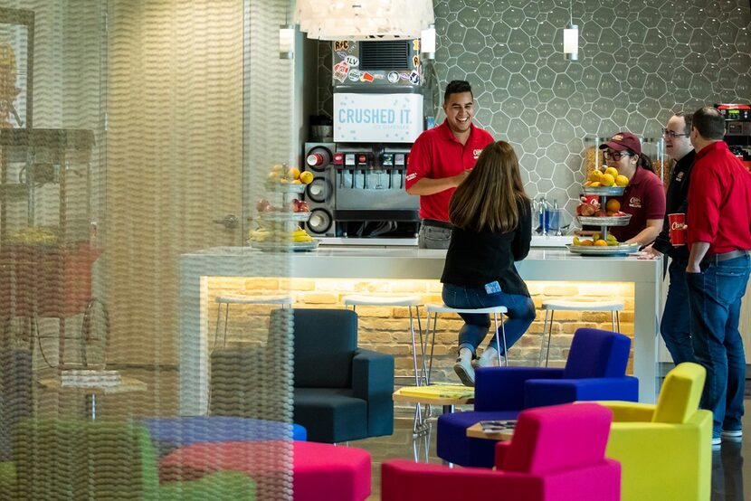  Assistant multimedia producer Ruben Guillen Jr. laughs with colleagues in a break area at...