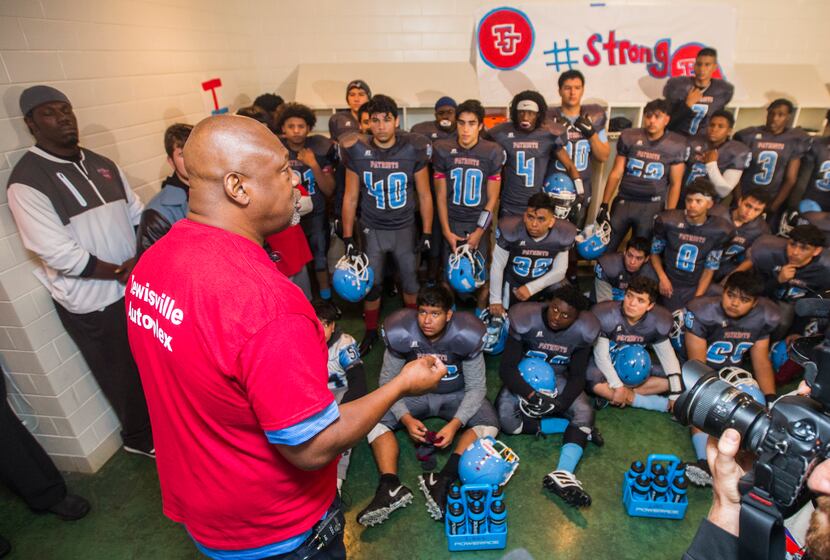 Former Cowboy Charles Haley talks with Thomas Jefferson High School football players in the...
