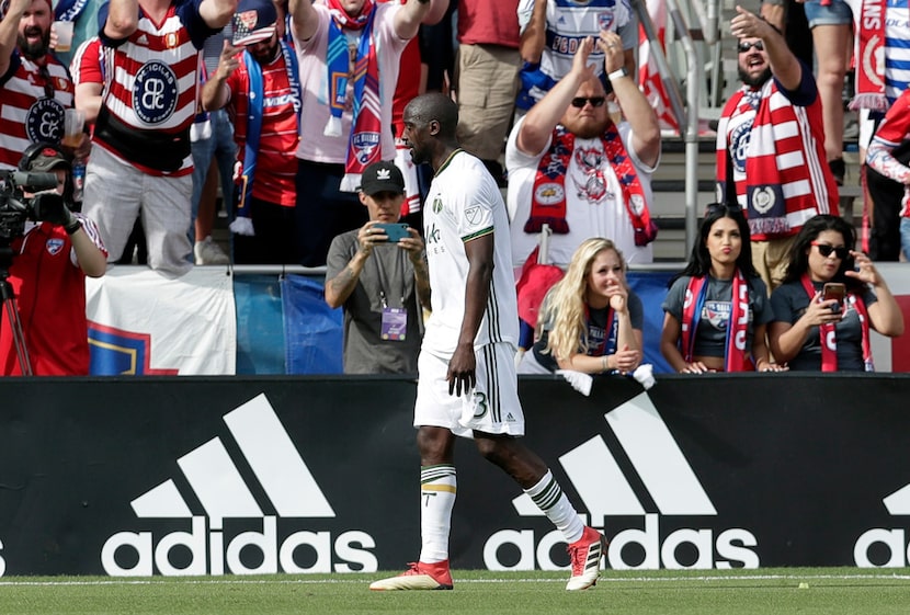 Portland Timbers midfielder Lawrence Olum (13) walks off the field as FC Dallas fans taunt...