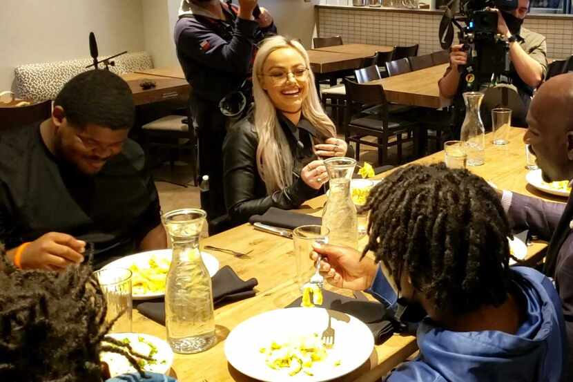 WWE stars Liv Morgan (middle) and Titus O'Neal (right) dine with staff at Cafe Momentum in...