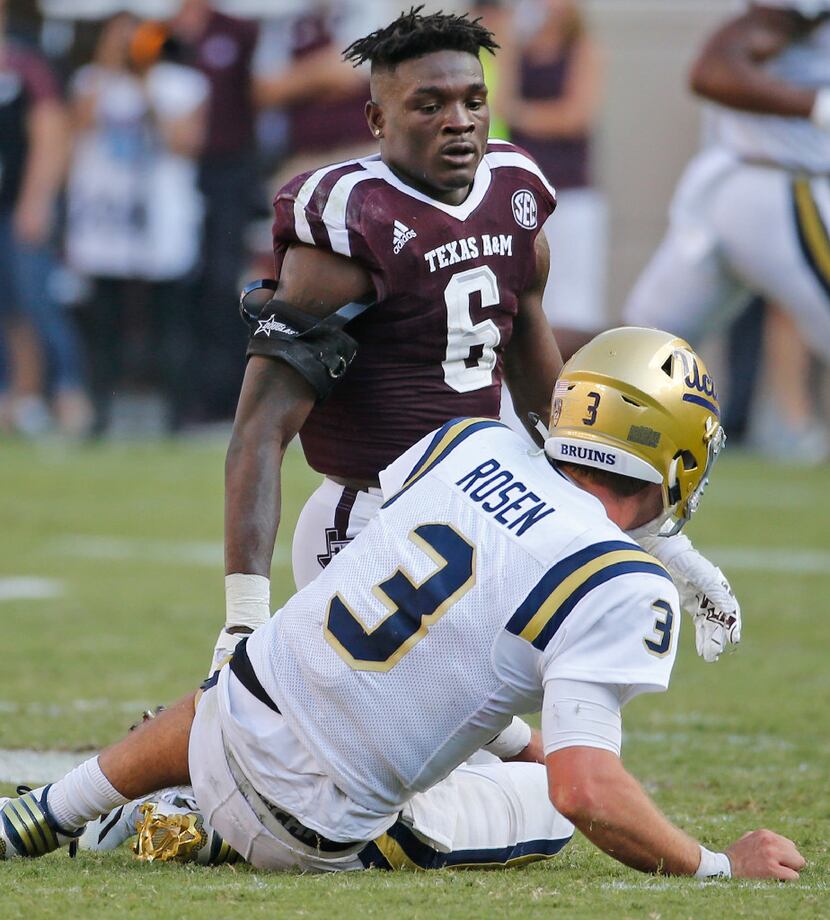 Texas A&M Aggies defensive back Donovan Wilson (6) loses his helmet after hitting UCLA...