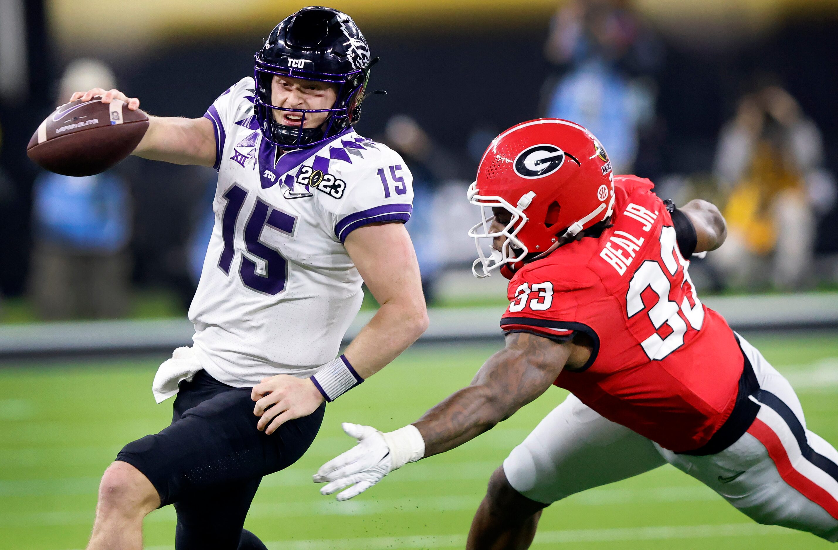 TCU Horned Frogs quarterback Max Duggan (15) races to the sideline as he’s pursued by...