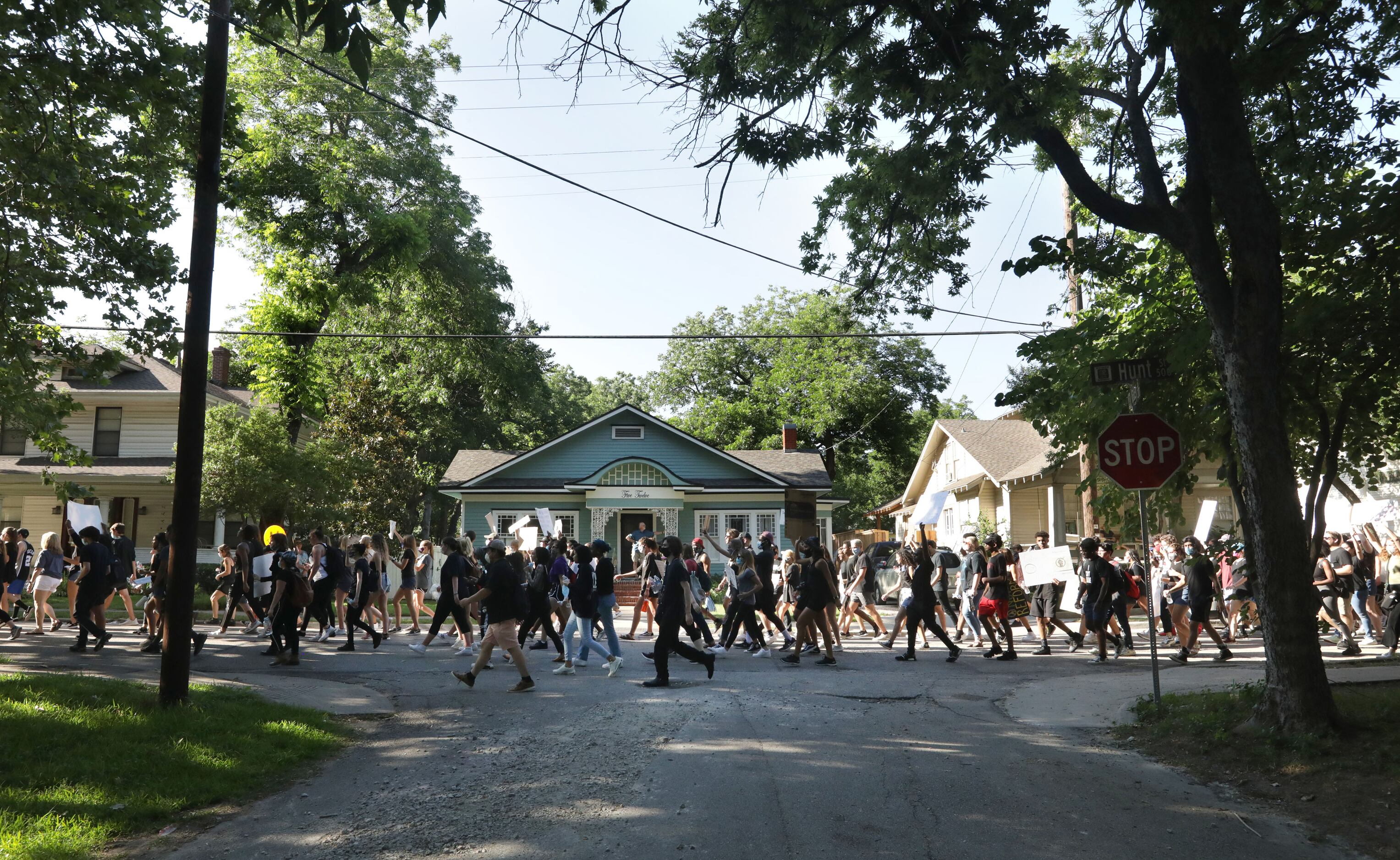 Protestors march from the historic town square back to Ron Poe Stadium in McKinney, TX, on...