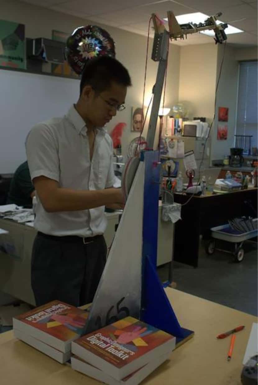 
North Hills junior Victor Yip works on a robot at the Irving charter school. Yip, like many...