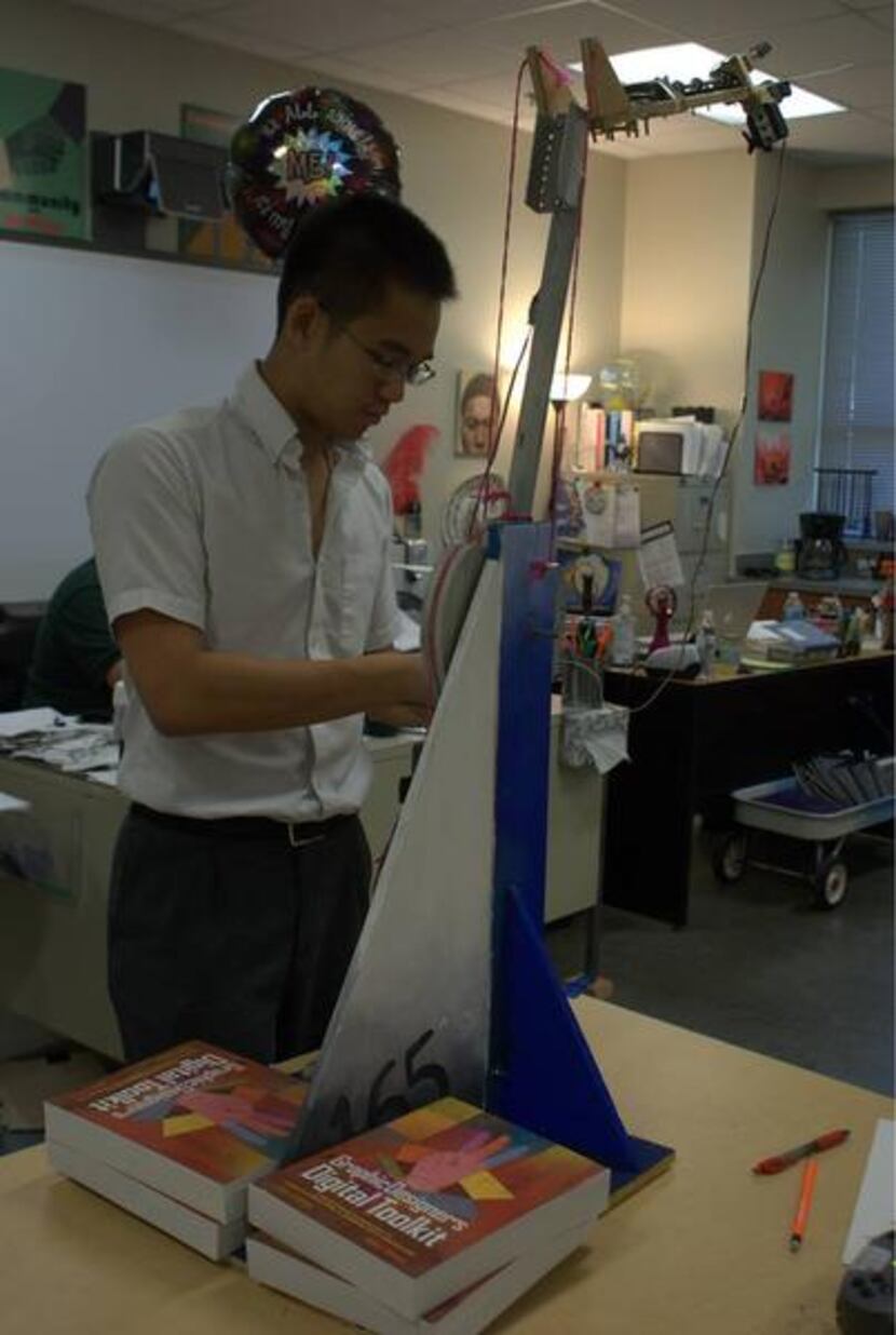 
North Hills junior Victor Yip works on a robot at the Irving charter school. Yip, like many...
