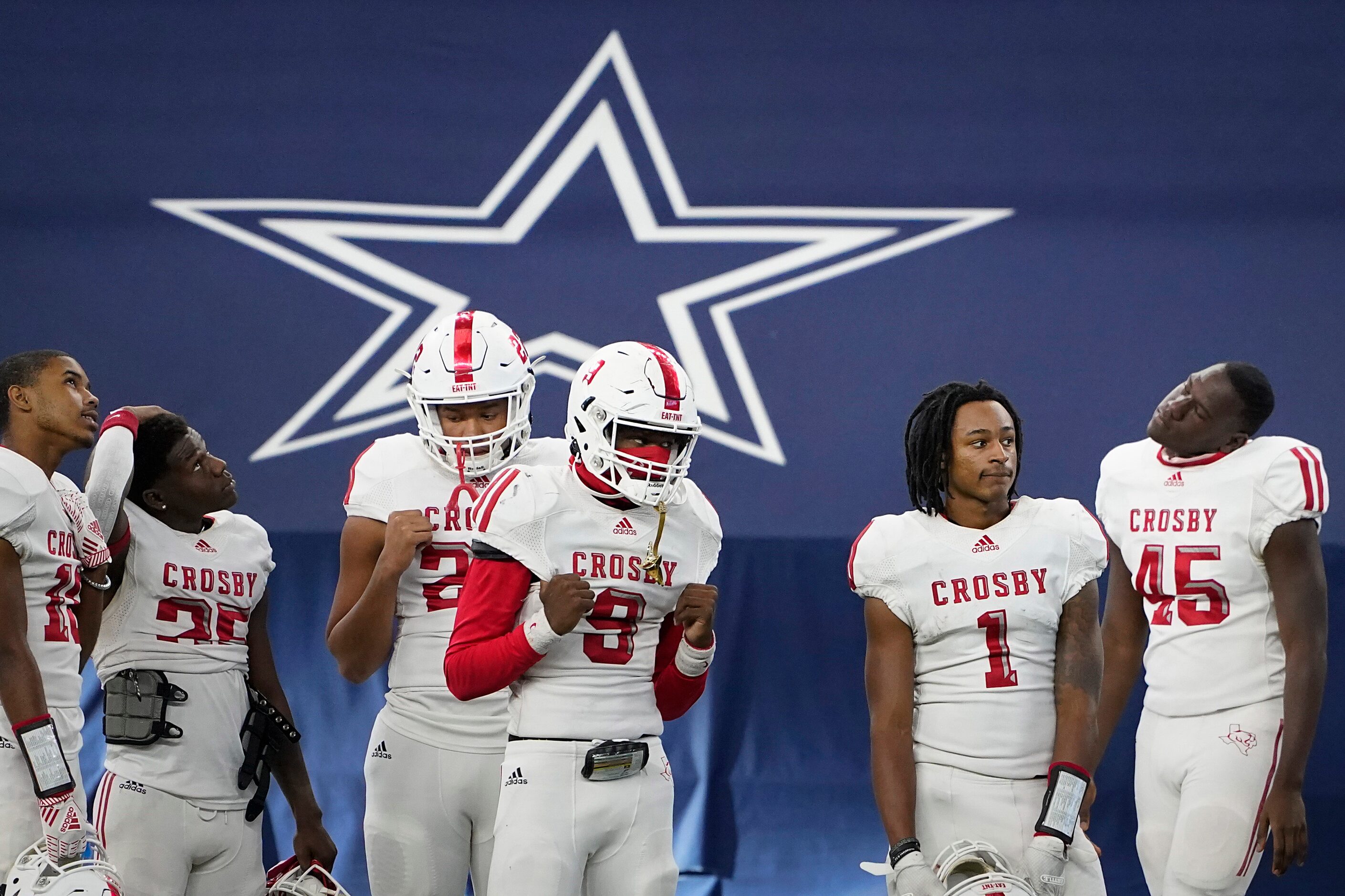 Crosby players watch from the sideline as Aledo players celebrate after a 56-21 victory in...