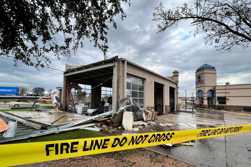 Storm damage is seen at Mustang Elite Car Wash & Lube Center on Ira E. Woods Avenue on...