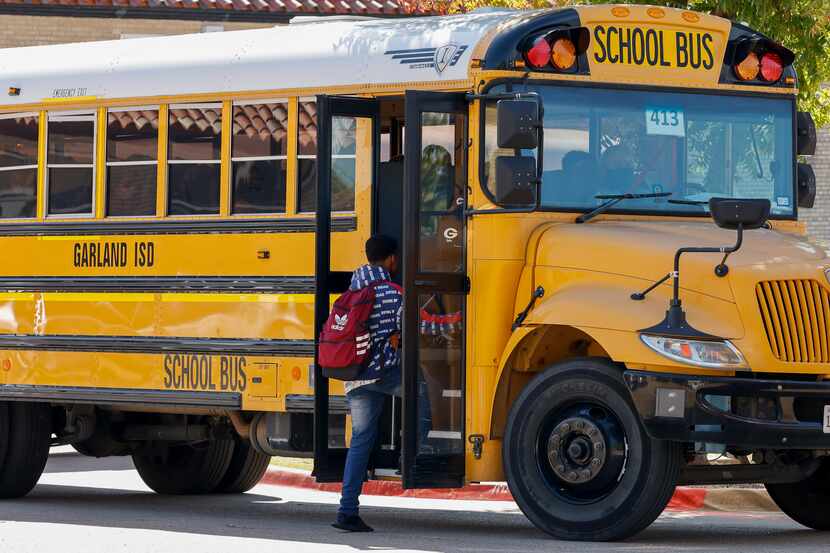 A student boards a bus outside Garland High School on Oct. 22.