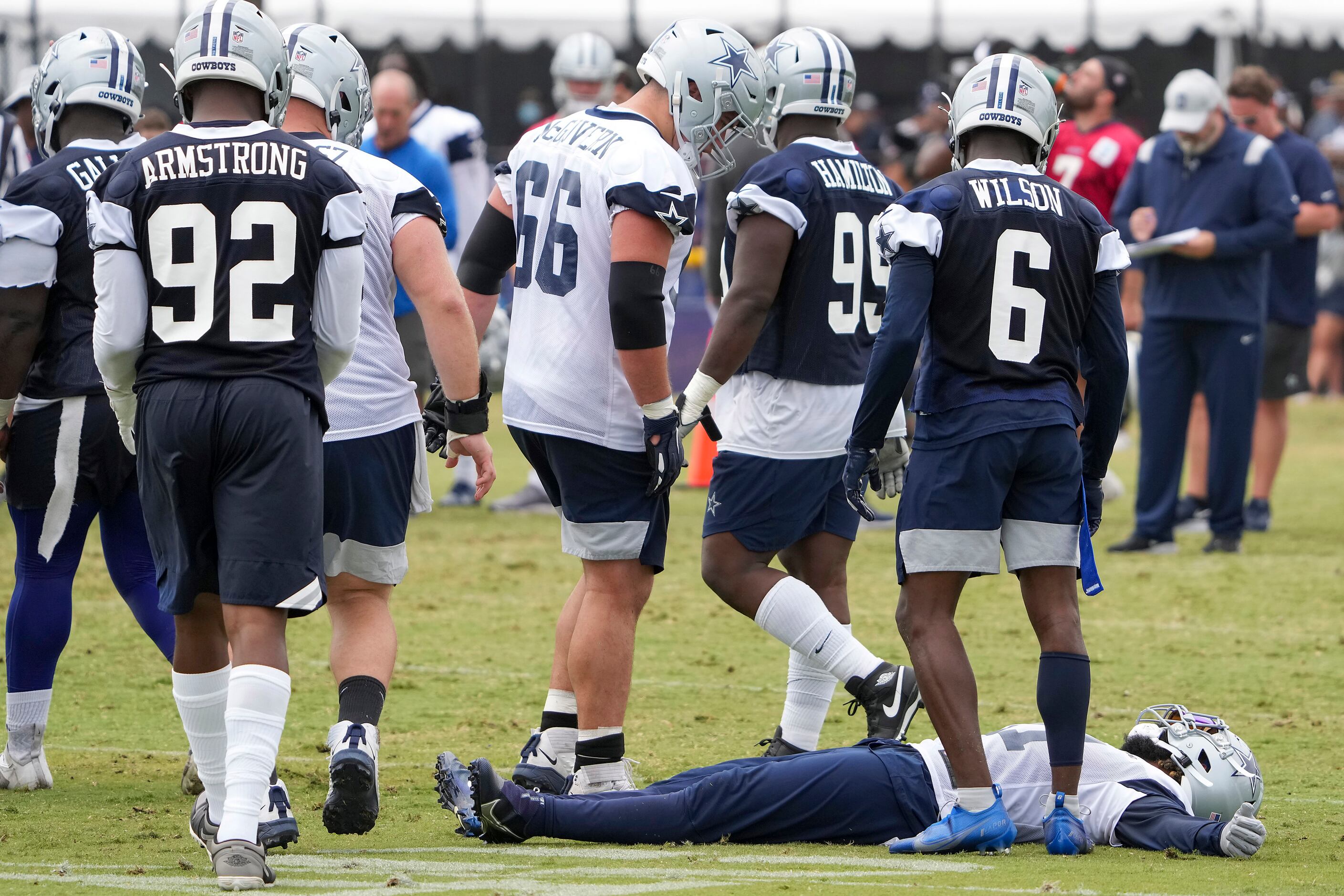 Dallas Cowboys running back Ezekiel Elliott (21) lies on the ground after slipping on a play...
