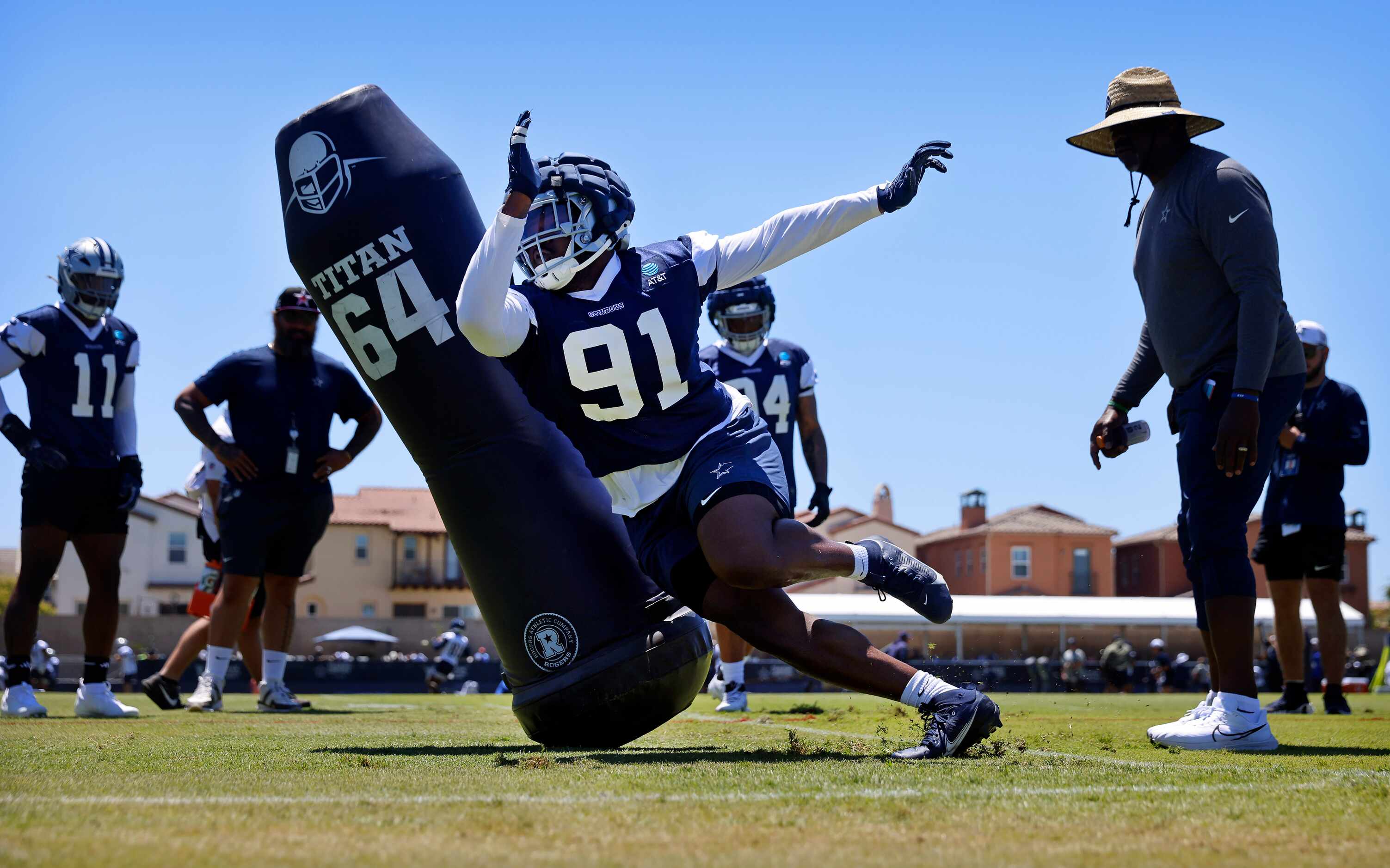 Dallas Cowboys defensive end Tyrus Wheat (91) turns the corner on a blocking dummy during a...
