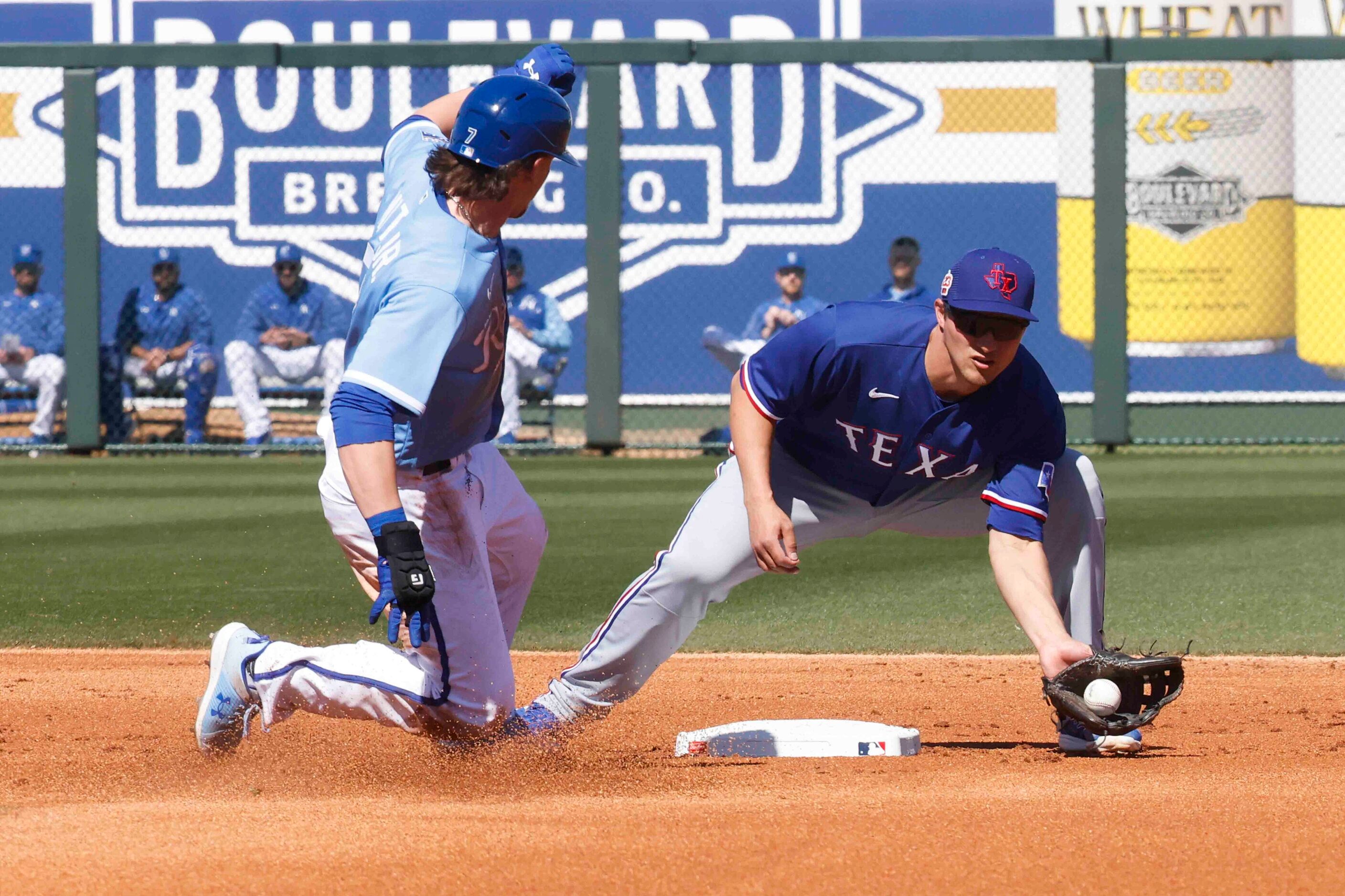 Kansas City Royals infielder Bobby Witt Jr., left, slides into the second base as Texas...